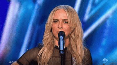 Woman Singing Into Microphone On Stage GIF