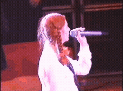 Woman Singing Into Microphone On Stage GIF