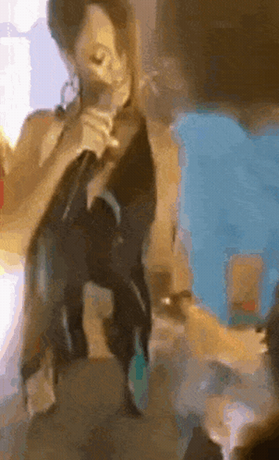 Woman Singing Into Microphone On Table GIF