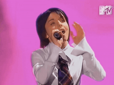 Woman Singing Into Microphone Pink Background GIF