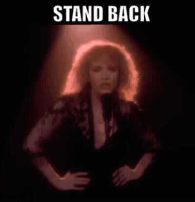 Woman Singing Into Microphone Saying Stand Back GIF