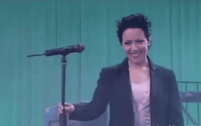 Woman Singing Into Microphone Smiling GIF