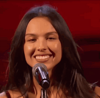 Woman Singing Into Microphone Smiling GIF