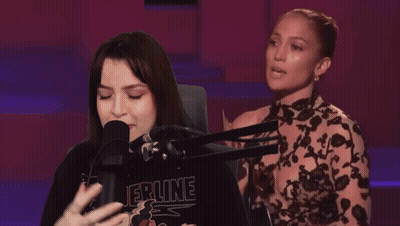 Woman Singing Into Microphone Wearing Epine Shirt GIF