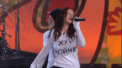 Woman Singing Into Microphone Wearing Shirt Saying ХУЙ GIF