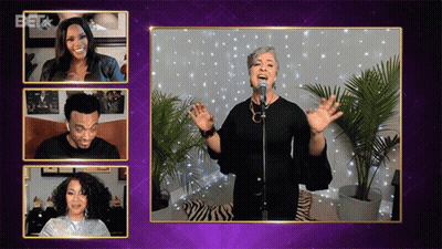 Woman Singing Into Microphone While Man And Woman Look On GIF