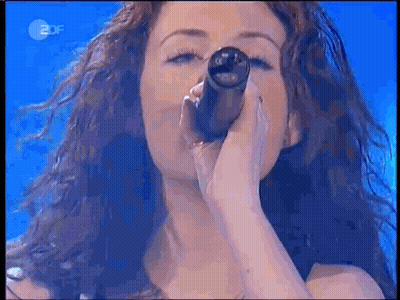 Woman Singing Into Microphone With 2DF Logo GIF