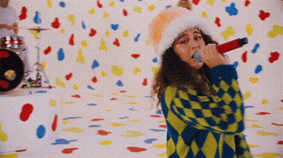 Woman Singing Into Microphone With Confetti GIF