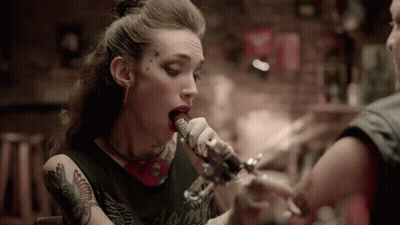 Woman Singing Into Microphone With Forehead Tattoo GIF