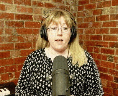Woman Singing Into Microphone With Glasses And Headphones GIF