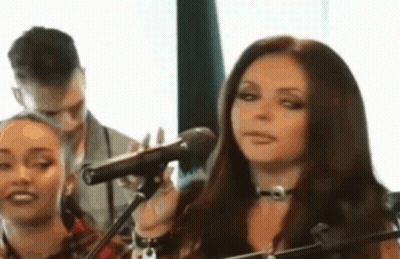 Woman Singing Into Microphone With Man Behind GIF