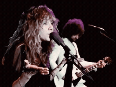 Woman Singing Into Microphone With Man Playing Guitar GIF