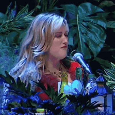 Woman Singing Into Microphone With Plants GIF