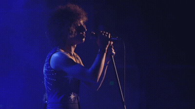 Woman Singing Into Microphone With Star GIF