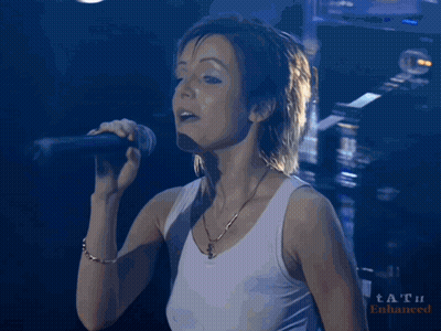 Woman Singing Into Microphone With Tat Watermark GIF