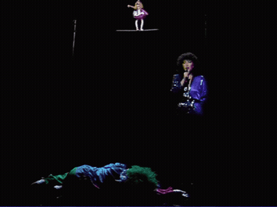 Woman Singing Into Microphone With Two Clowns GIF