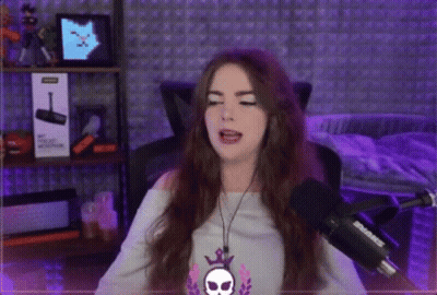 Woman Singing Into Shure Microphone With Headphones And Skull Necklace GIF