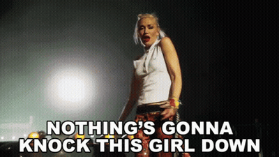 Woman Singing Nothing's Gonna Knock This Girl Down In Dark Room GIF