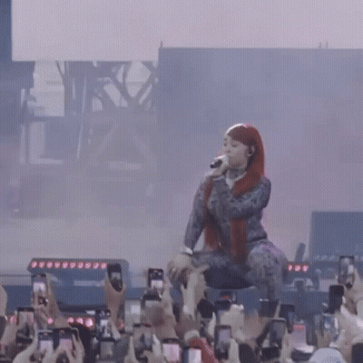 Woman Singing On Stage Crowd Taking Pictures With Phones GIF