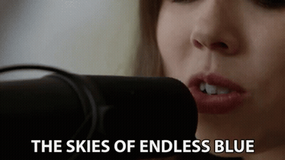Woman Singing Skies Of Endless Blue Into Microphone GIF