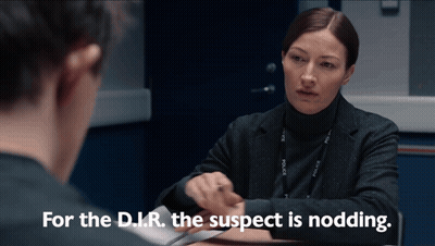 Woman Sits At Table And Says For The D.I.R. The Suspect Is Nodding GIF