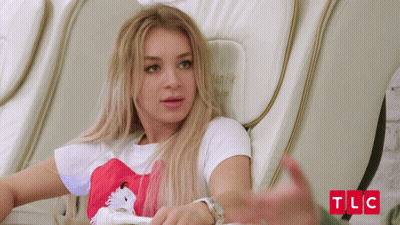 Woman Sits In Chair With TLC Written In Red GIF