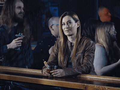 Woman Sitting At Bar Holding Drink GIF
