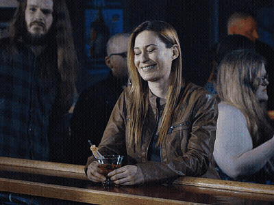 Woman Sitting At Bar Holding Martini GIF