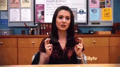 Woman Sitting At Desk In Front Of Citytv Sign GIF