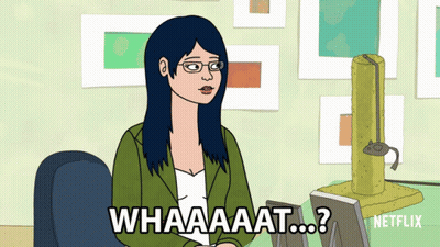 Woman Sitting At Desk Saying What GIF