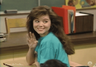 Woman Sitting At Desk Waving GIF