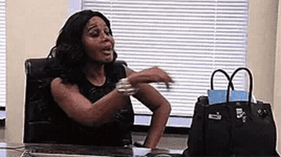 Woman Sitting At Desk With Arms Outstretched GIF