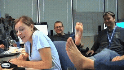 Woman Sitting At Desk With Feet On Man GIF