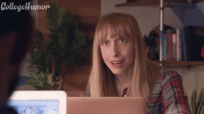 Woman Sitting At Desk With Laptop Making Funny Face GIF
