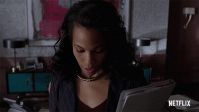 Woman Sitting At Desk With Netflix Logo GIF