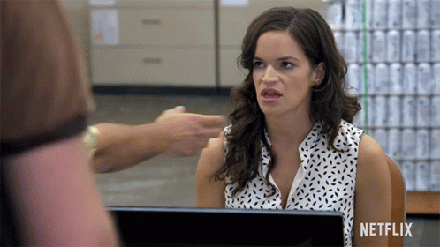 Woman Sitting At Desk With Netflix Logo GIF