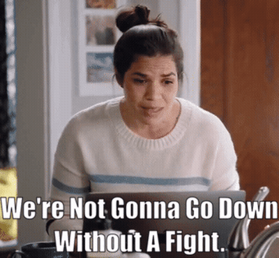 Woman Sitting At Laptop With We're Not Gonna Go Down Without A Fight Meme GIF