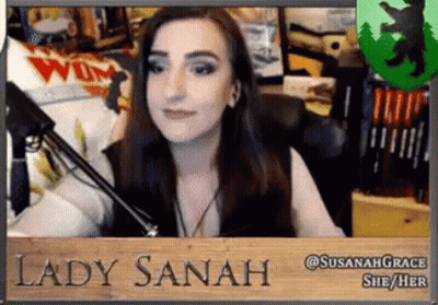 Woman Sitting At Microphone With Lady Sanah Sign GIF