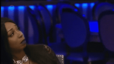 Woman Sitting At Microphone With Number 5 On Screen GIF
