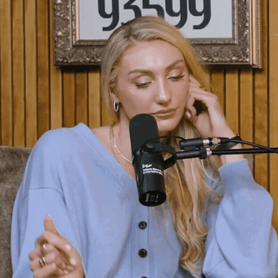 Woman Sitting At Microphone With Sign 93599 GIF