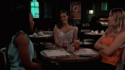 Woman Sitting At Restaurant Table GIF