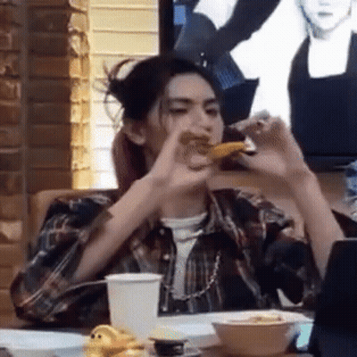 Woman Sitting At Table Eating GIF