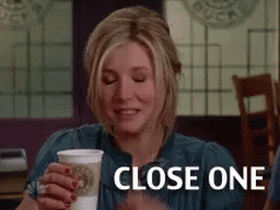 Woman Sitting At Table Holding Coffee GIF
