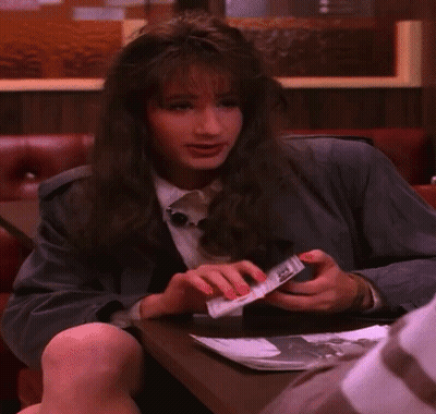 Woman Sitting At Table Holding DEA Passport GIF