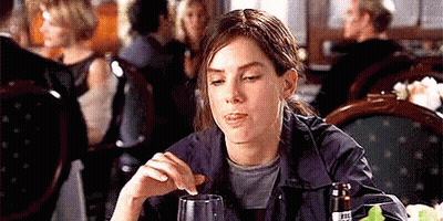 Woman Sitting At Table Holding Glass Of Wine GIF
