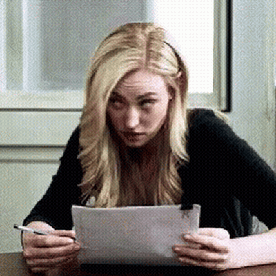 Woman Sitting At Table Holding Paper GIF