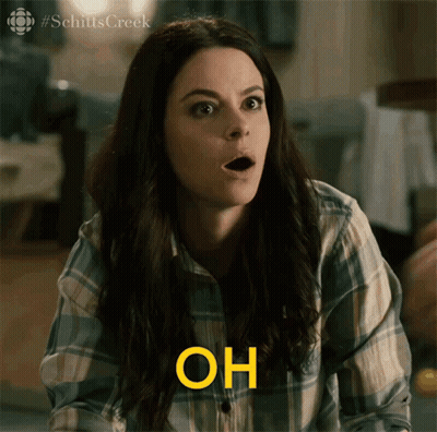 Woman Sitting At Table Holding Paper GIF