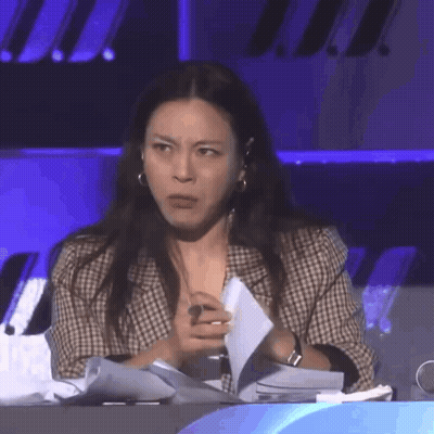 Woman Sitting At Table Holding Paper GIF