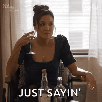 Woman Sitting At Table Holding Wine Saying Just Sayin GIF