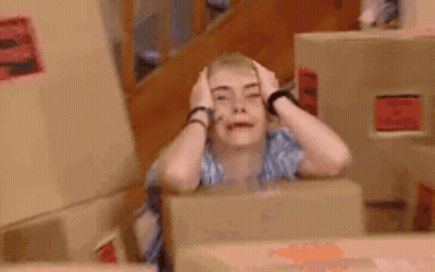 Woman Sitting At Table Making Funny Face GIF